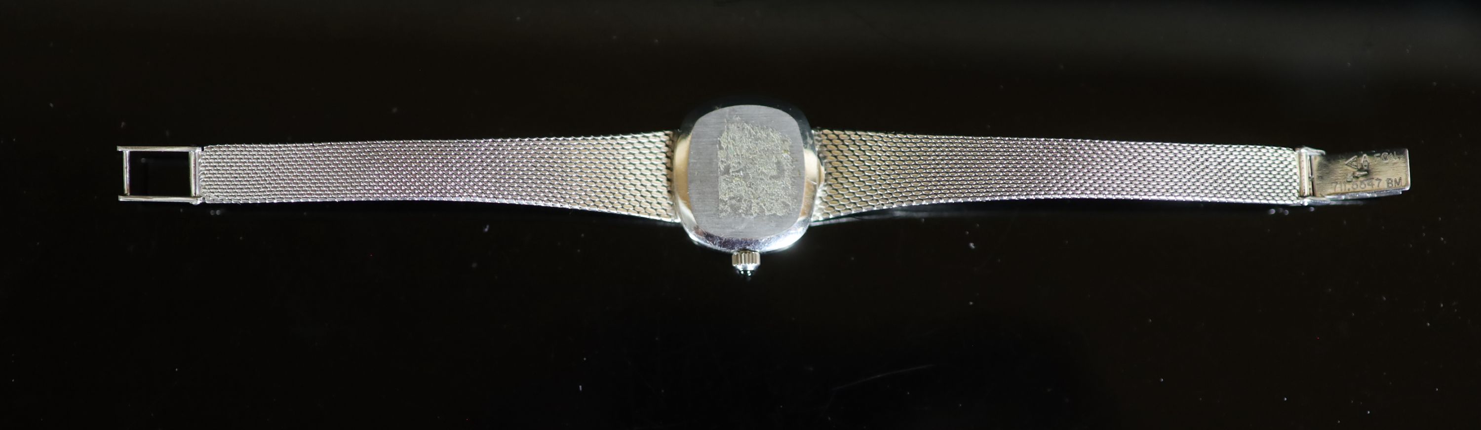 A lady's modern 9ct white gold Omega manual wind wrist watch, on an integral Omega 9ct white gold bracelet